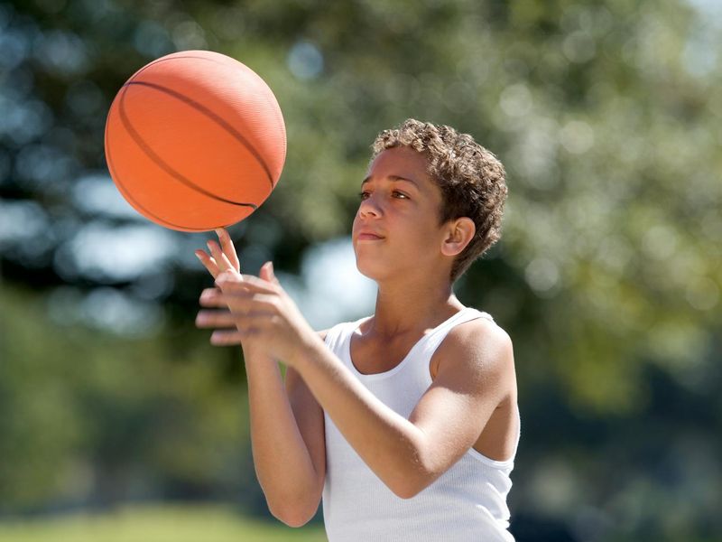 Person focused on a specific exercise movement in a bright room.